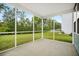 This screened porch offers a tranquil outdoor space with views of the expansive, green lawn and lush trees at 234 Daniels Creek Cir, Goose Creek, SC 29445