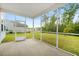 Enjoy outdoor living from this screened-in porch, offering views of the manicured lawn and a peaceful backyard pond at 234 Daniels Creek Cir, Goose Creek, SC 29445
