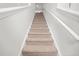 Carpeted staircase with white railing leads to the upper level of the home at 234 Daniels Creek Cir, Goose Creek, SC 29445