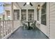 Covered back porch featuring a ceiling fan, lighting, and an outdoor dining set at 24 Hanover St, Charleston, SC 29403