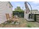 Relaxing backyard featuring wooden chairs, table and an umbrella for shade at 24 Hanover St, Charleston, SC 29403
