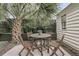 Outdoor seating area surrounded by trees offers a private space at 24 Hanover St, Charleston, SC 29403