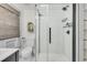 Modern bathroom featuring a glass-enclosed shower with vertical tiling and sleek black hardware at 24 Hanover St, Charleston, SC 29403