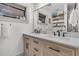 Bathroom featuring a double sink vanity with wood cabinets and a glass shower at 24 Hanover St, Charleston, SC 29403
