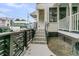 Side entrance to the home with decorative tiled steps and black metal railing at 24 Hanover St, Charleston, SC 29403