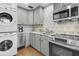 Bright kitchen features stainless steel appliances, gray cabinetry and an artistic backsplash at 24 Hanover St, Charleston, SC 29403