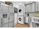 Bright kitchen featuring stainless steel appliances, gray cabinets and a stacked washer and dryer at 24 Hanover St, Charleston, SC 29403