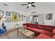 Inviting living room with a plush red sofa, colorful art, and a view through french doors at 24 Hanover St, Charleston, SC 29403