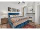 Bright main bedroom features a blue velvet bed, fireplace, and stylish decor at 24 Hanover St, Charleston, SC 29403