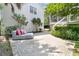 Outdoor patio area features a comfortable lounge chair with a beautiful view of the house and lush landscaping at 2405 Louisville St, Charleston, SC 29492