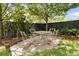 Charming backyard features an outdoor dining area with a metal table and four matching chairs on a brick patio at 2405 Louisville St, Charleston, SC 29492