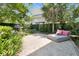 Lush backyard with a comfortable lounge chair and pillow decorations for outdoor relaxation and privacy at 2405 Louisville St, Charleston, SC 29492