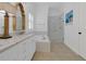 Bright bathroom with a double vanity, soaking tub, glass-enclosed shower, and stylish fixtures at 2405 Louisville St, Charleston, SC 29492