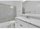Bright bathroom featuring a vanity with marble countertop and bathtub with glass doors at 2405 Louisville St, Charleston, SC 29492