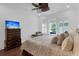 Bedroom with a comfortable bed, wood dresser, natural light, and a ceiling fan at 2405 Louisville St, Charleston, SC 29492