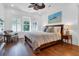 Bedroom features a wood bed, decorative pillows, neutral tones, and natural light from shuttered windows at 2405 Louisville St, Charleston, SC 29492