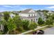 Charming two-story home featuring a metal roof, inviting front porch, and professionally landscaped yard at 2405 Louisville St, Charleston, SC 29492