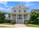 Charming two-story home featuring a welcoming front porch, classic design, and well-maintained landscaping at 2405 Louisville St, Charleston, SC 29492