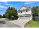 Detached two-car garage with white doors, classic shutters, and a well-maintained driveway and yard at 2405 Louisville St, Charleston, SC 29492