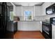 Bright kitchen featuring stainless steel appliances, granite countertops, and white cabinets, a chef's dream at 2405 Louisville St, Charleston, SC 29492