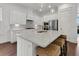 Well-lit kitchen with white cabinets, stainless steel appliances, a center island, and a marble backsplash at 2405 Louisville St, Charleston, SC 29492
