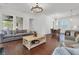 Spacious open-concept living room with hardwood floors, a fireplace, and a dining area, perfect for entertaining at 2405 Louisville St, Charleston, SC 29492