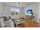 Bright living room with a large window, stylish decor, and comfortable seating, perfect for relaxing and entertaining at 2405 Louisville St, Charleston, SC 29492