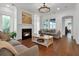 Bright living room with a fireplace, hardwood floors, and stylish furniture, creating a cozy and inviting atmosphere at 2405 Louisville St, Charleston, SC 29492