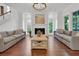 Elegant living room with hardwood floors, fireplace, and beach painting, creating a comfortable and welcoming atmosphere at 2405 Louisville St, Charleston, SC 29492