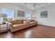 Bright living room featuring hardwood floors, large windows, and a comfortable leather sofa at 2405 Louisville St, Charleston, SC 29492