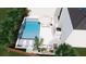 A luxurious pool design with in-pool loungers, outdoor seating, and lush landscaping at 2405 Louisville St, Charleston, SC 29492
