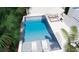An inviting swimming pool with built-in loungers and clear blue water, surrounded by vibrant greenery at 2405 Louisville St, Charleston, SC 29492