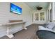 Relaxing porch view featuring an outdoor ceiling fan, console table, and comfortable seating area at 2405 Louisville St, Charleston, SC 29492