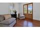 Cozy sitting room with wood floors, comfortable seating, and natural light from the windows and glass doors at 2405 Louisville St, Charleston, SC 29492