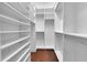 Spacious walk-in closet with white shelving and hardwood floors at 2405 Louisville St, Charleston, SC 29492