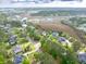 An aerial view captures a house nestled among trees, showcasing the expansive marshland beyond at 2444 Darts Cove Way, Mount Pleasant, SC 29466