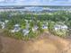 Aerial view of a home nestled within a lush, wooded neighborhood near a scenic waterway at 2444 Darts Cove Way, Mount Pleasant, SC 29466