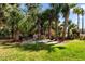 Serene backyard setting with a comfortable bench, stone patio and lush greenery at 2444 Darts Cove Way, Mount Pleasant, SC 29466