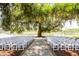 Charming outdoor wedding venue setup featuring white chairs arranged around a picturesque tree at 2444 Darts Cove Way, Mount Pleasant, SC 29466
