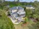 Beautiful multi-story home with balconies, screened porch, and charming outdoor living spaces at 2444 Darts Cove Way, Mount Pleasant, SC 29466