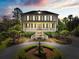 Beautiful two-story home with front porch and circular driveway with fountain at 2444 Darts Cove Way, Mount Pleasant, SC 29466
