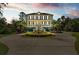 Traditional style home with a manicured lawn, elegant fountain, and circular driveway at 2444 Darts Cove Way, Mount Pleasant, SC 29466