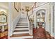 Grand foyer with hardwood floors, staircase, and detailed trim work at 2444 Darts Cove Way, Mount Pleasant, SC 29466