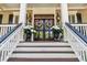 Welcoming front entrance with a double door, adorned with elegant floral arrangements and lush potted plants at 2444 Darts Cove Way, Mount Pleasant, SC 29466