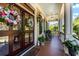 Inviting front porch with decorative floral wreaths, hanging lanterns, and comfortable rocking chairs at 2444 Darts Cove Way, Mount Pleasant, SC 29466