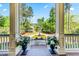Charming view from front porch, showcasing landscape, circular driveway and lush greenery beyond at 2444 Darts Cove Way, Mount Pleasant, SC 29466