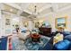 Bright living room boasts tray ceilings, hardwood floors, and ample seating at 2444 Darts Cove Way, Mount Pleasant, SC 29466