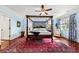 Beautiful bedroom with a four-poster bed, wood floors, and ample natural light at 2444 Darts Cove Way, Mount Pleasant, SC 29466