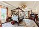 Spacious main bedroom with a four-poster bed, ceiling fan, and abundant natural light at 2444 Darts Cove Way, Mount Pleasant, SC 29466