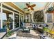 Inviting covered patio featuring comfortable seating, ceiling fan, and stylish decor at 2444 Darts Cove Way, Mount Pleasant, SC 29466